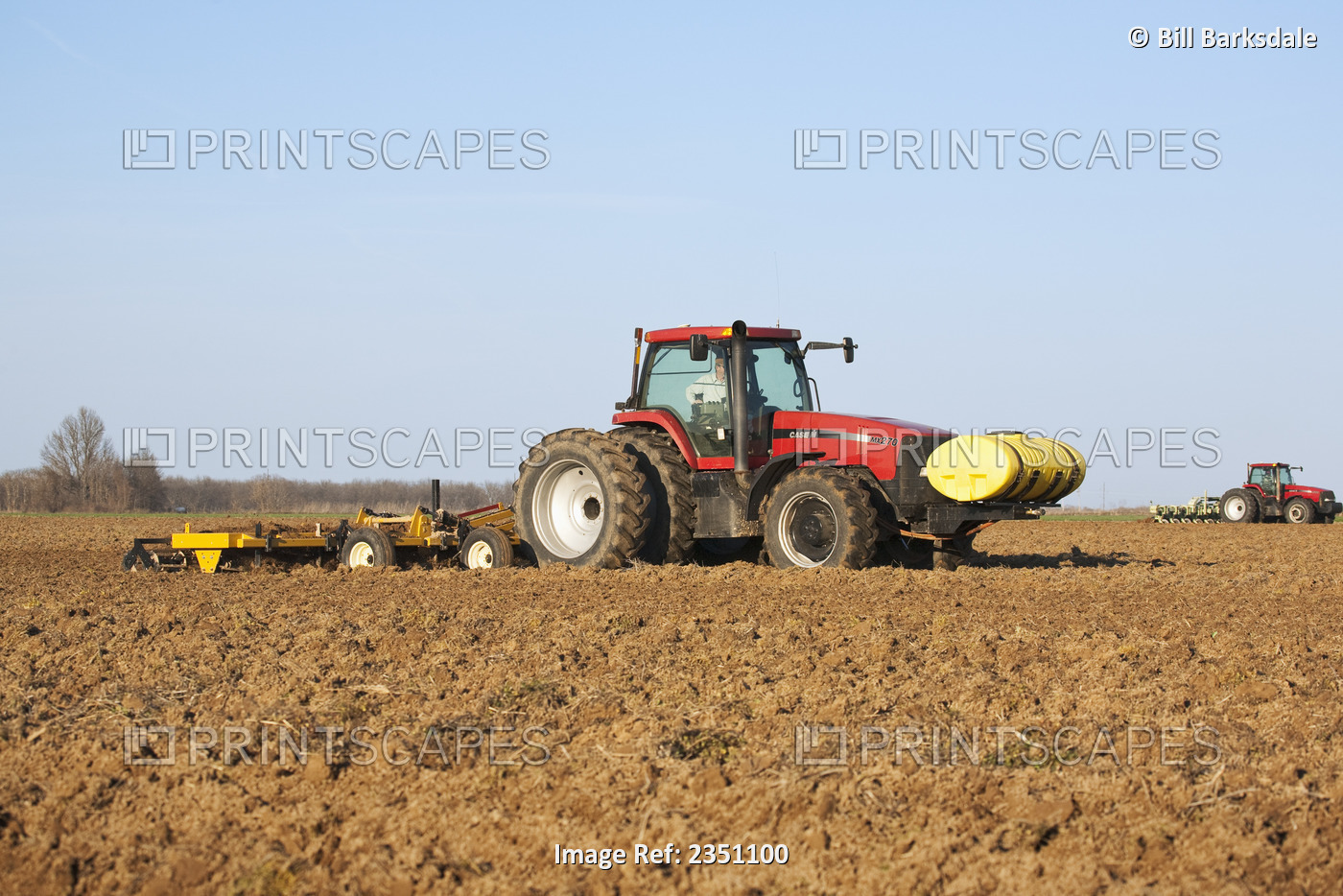 Agriculture - Two Case IH tractors and field implements finish soil preparation ...