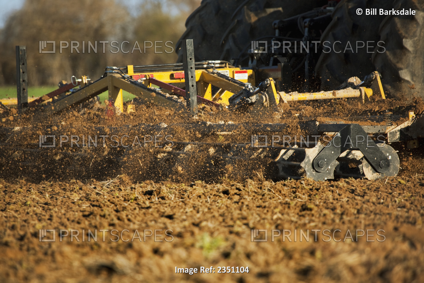 Agriculture - Closeup of a field implement finishing soil preparation of a ...