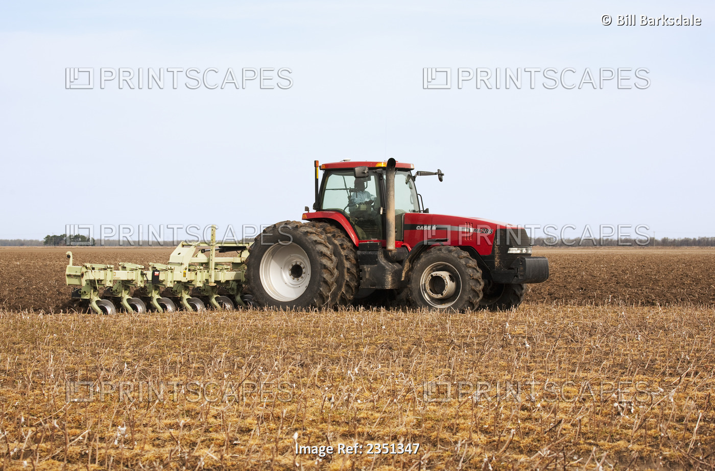 Agriculture - A Case IH tractor and field implement prepare a field in late ...