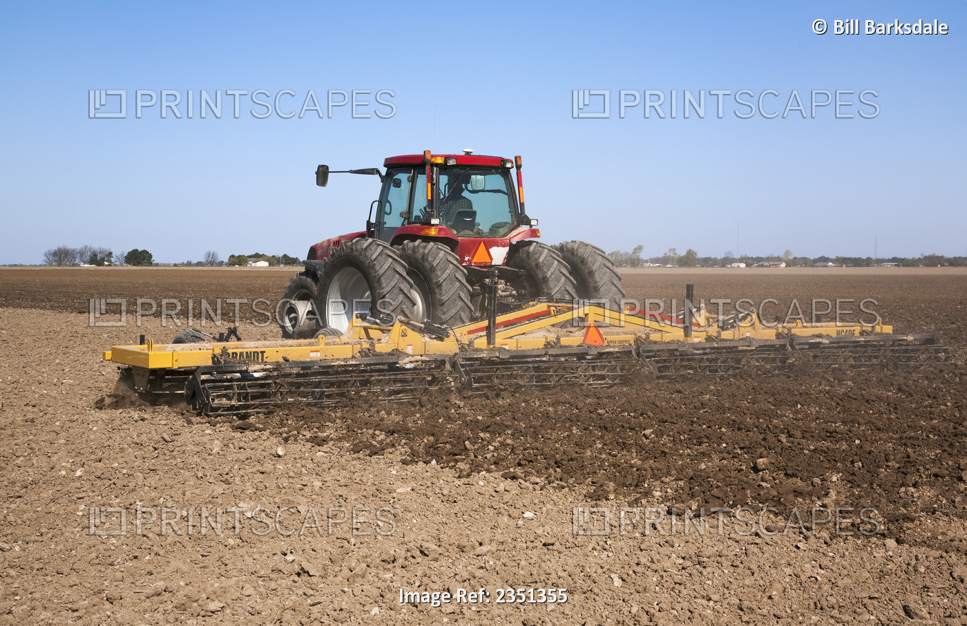 Agriculture - A Case IH tractor and field implement prepare bedded soil in a ...