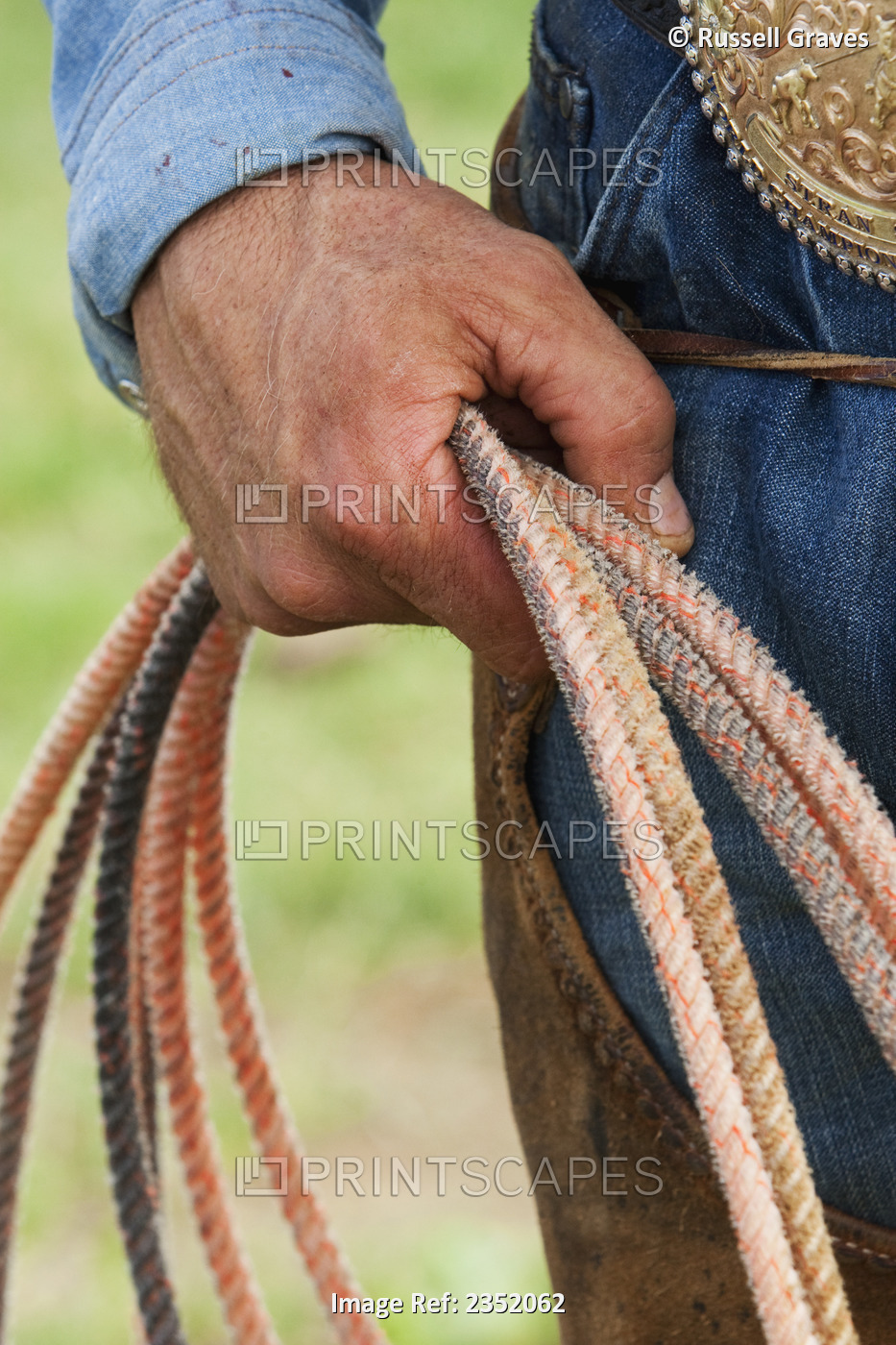 Agriculture - Detail of a cowboy holding a coiled rope / Childress, Texas, USA.