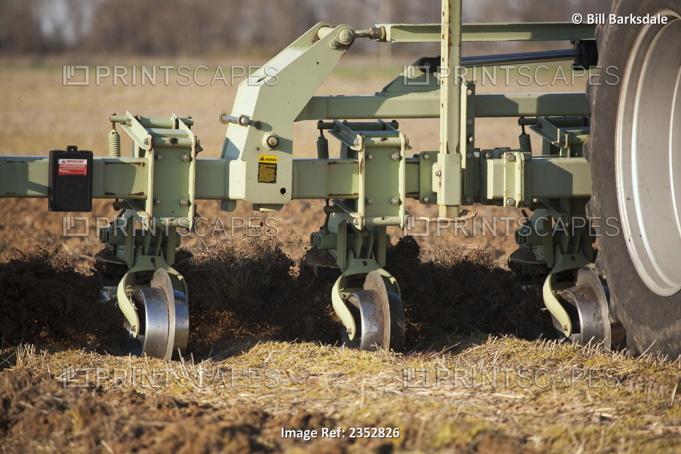 Agriculture - Closeup of a field implement preparing a field in late Spring for ...