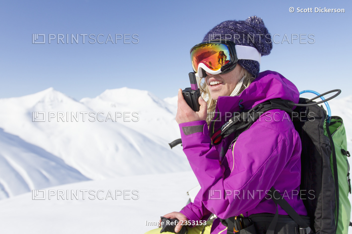 Woman Talking On A Two-Way Radio While Backcountry Skiing By Snowmobile In The ...