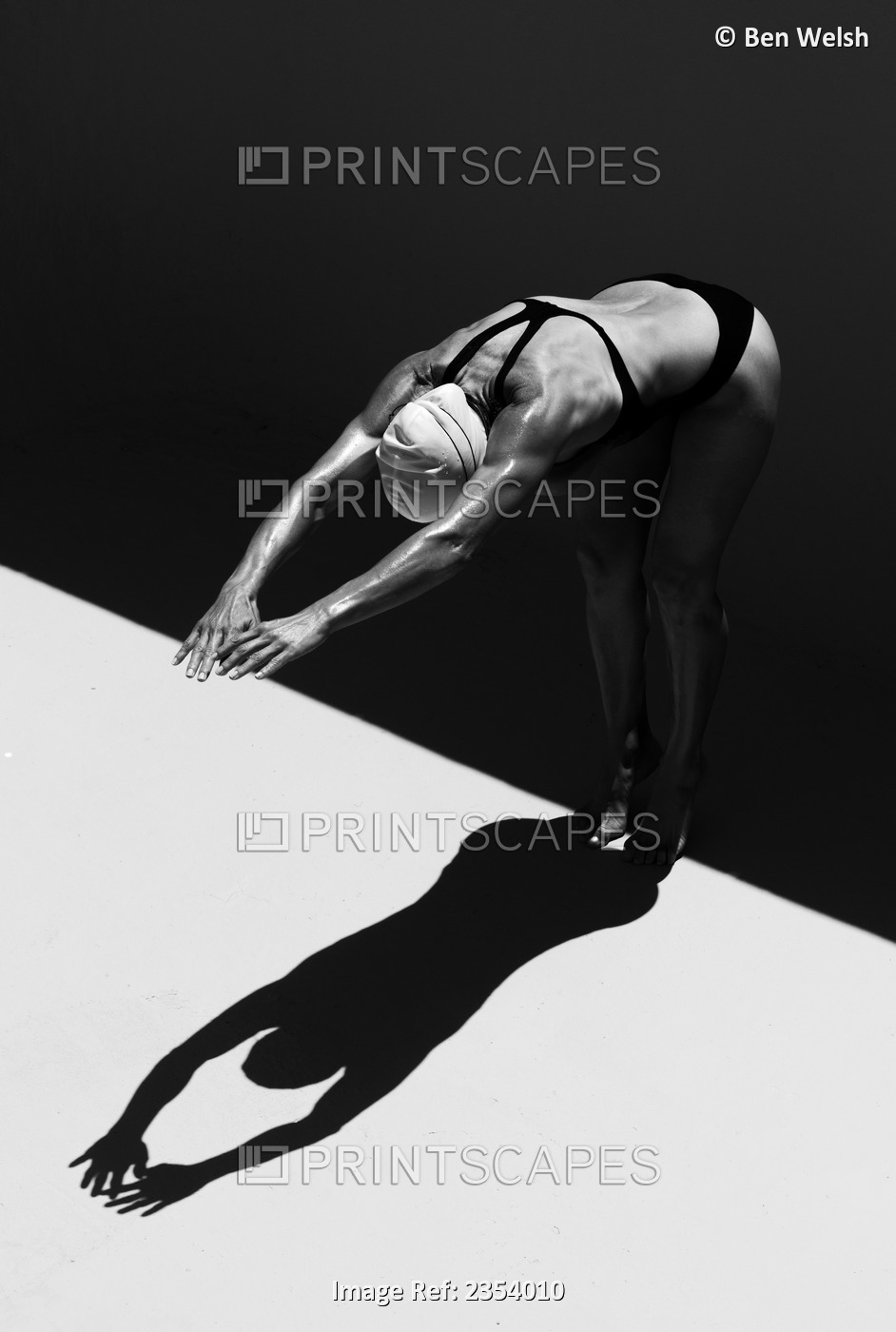A Woman Prepares To Jump Backwards Off The Edge Of A Pool Into The Water; ...