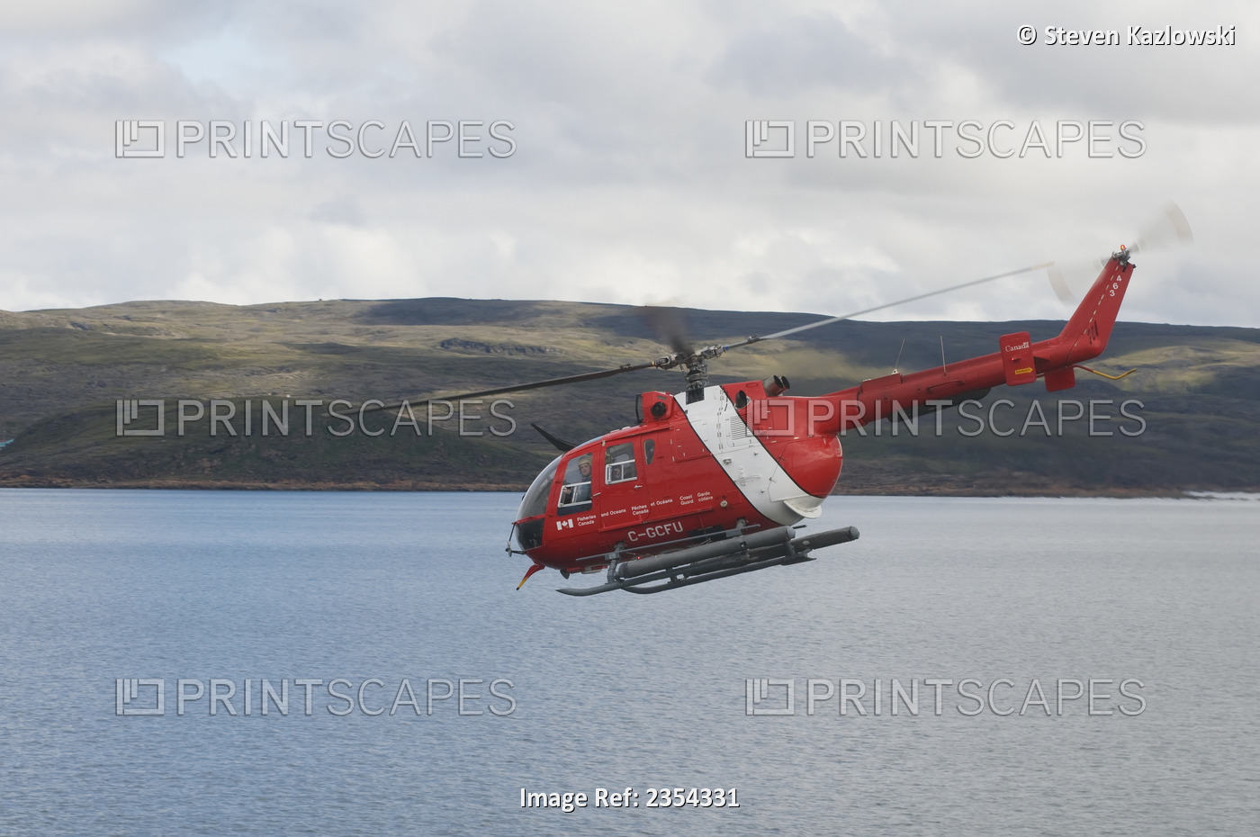 Canadian Coast Guard Helicopter In Flight Over Water; Iqualuit, Baffin Island, ...