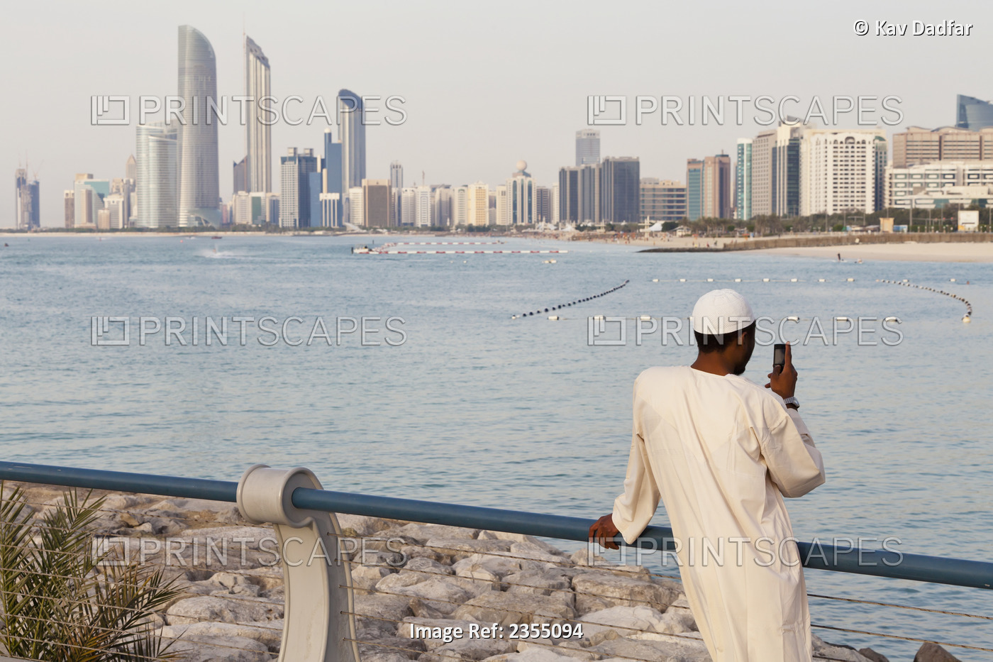 Local Uae Man Looking At Abu Dhabi Cityscape; Abu Dhabi, United Arab Emirates