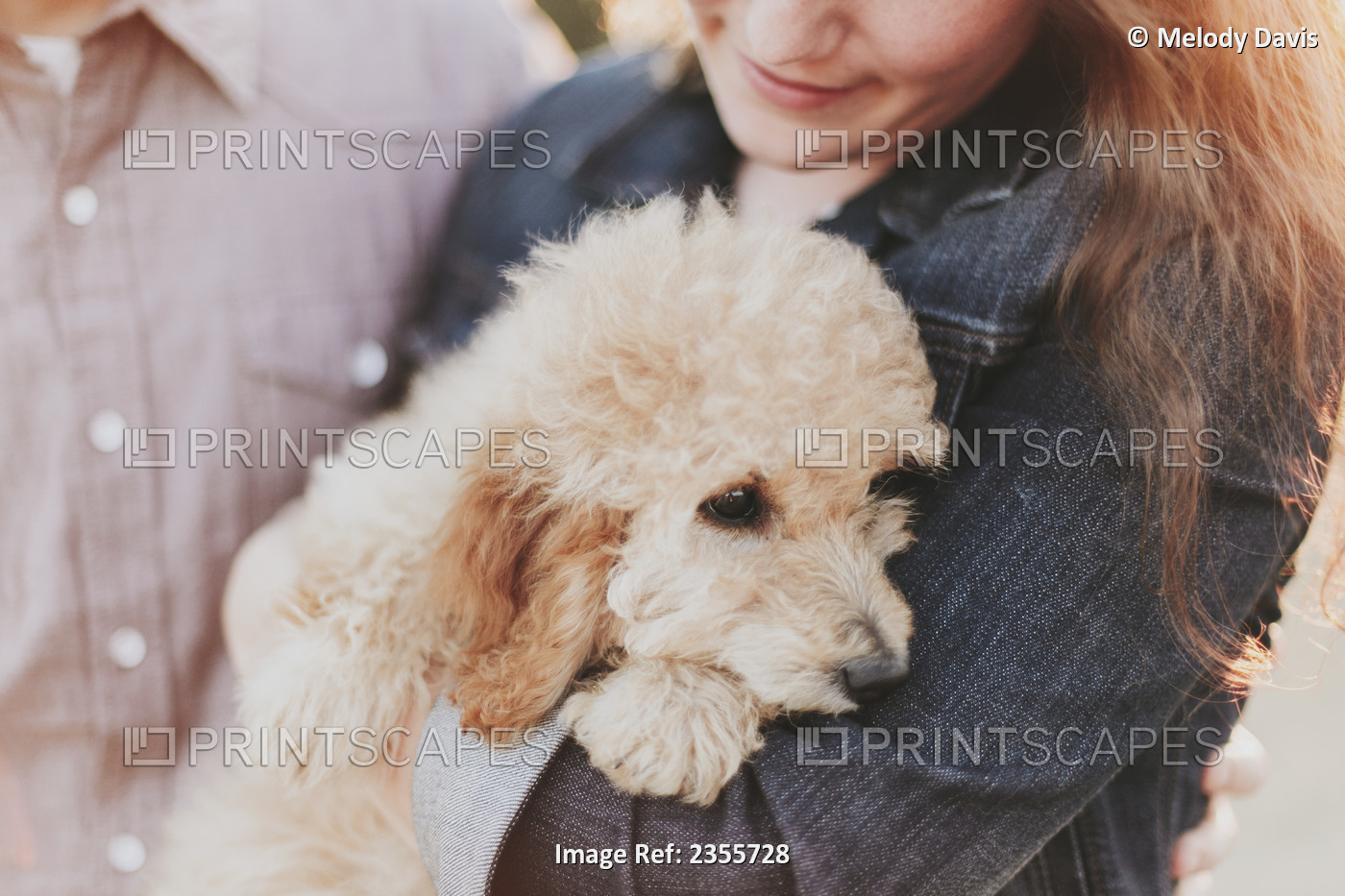 A Woman Holds Her Pet Dog In Her Arms; Crescent Beach, British Columbia, Canada