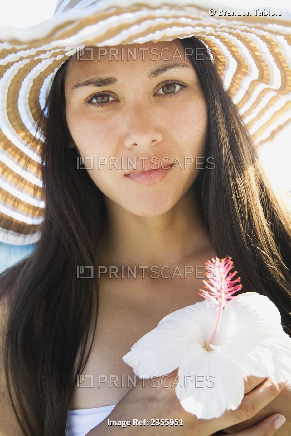 Portrait Of A Young Woman In A Sunhat Holding An Hibiscus Flower; Waikiki, ...