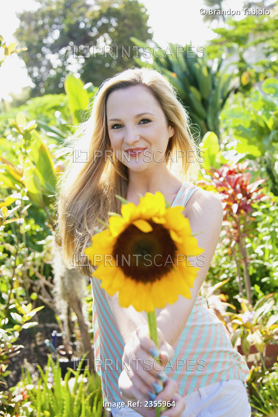 Portrait Of A Girl Holding A Sunflower; Honolulu, Oahu, Hawaii, United States ...