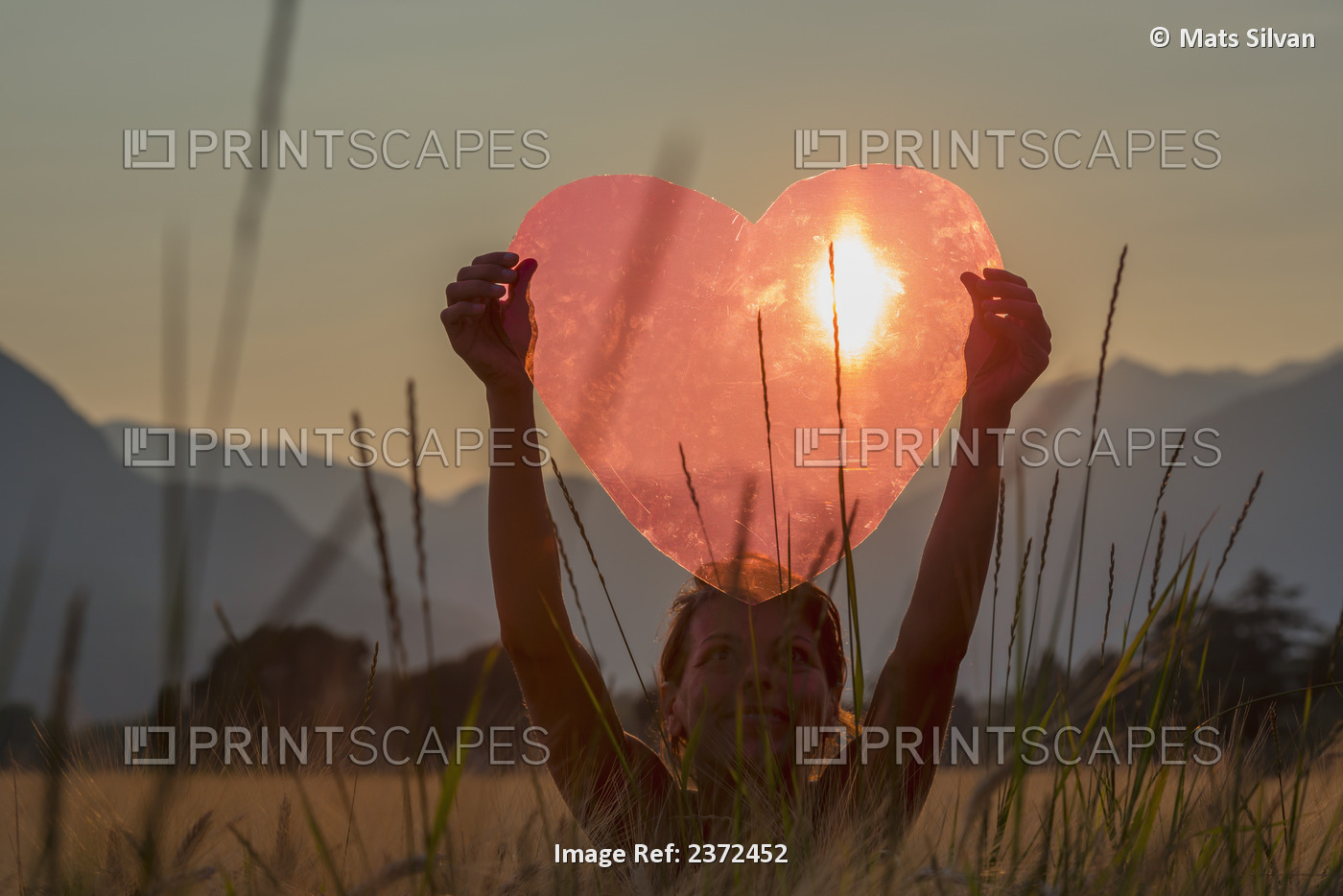 A Woman Holds Up A Red Heart With The Sun To Shine Through; Locarno, Ticino, ...