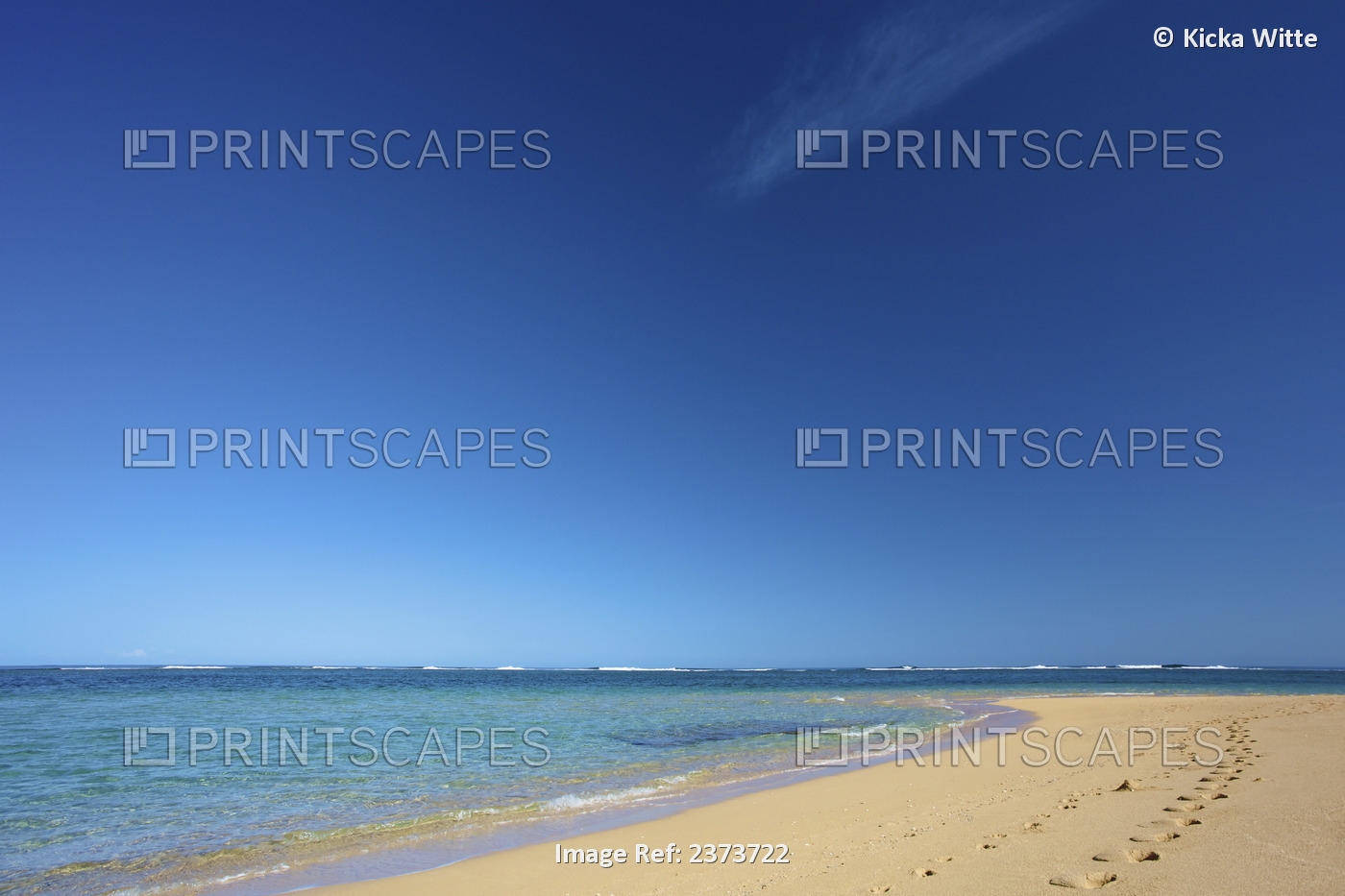 Footprints In The Sand Along The Water's Edge Of Tunnels Beach; Kauai, Hawaii, ...