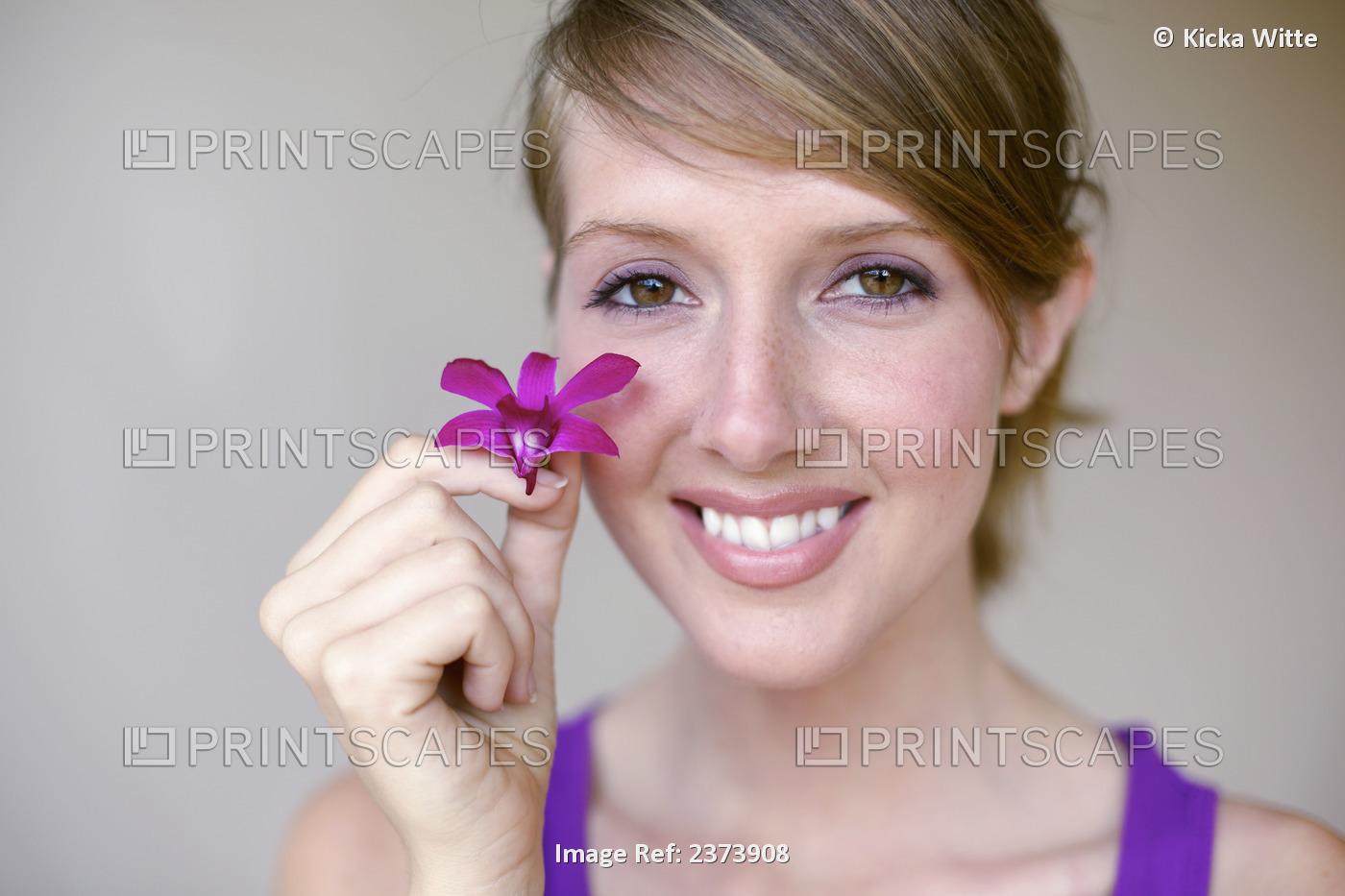 Portrait Of A Young Woman Holding A Tropical Flower; Kauai, Hawaii, United ...