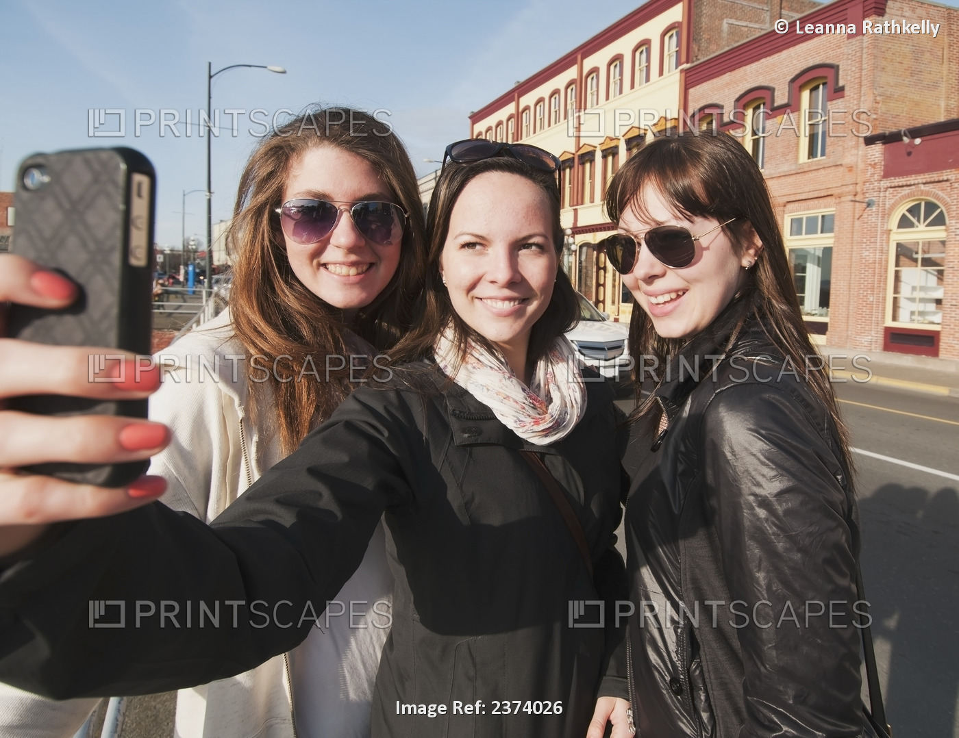 Three Young Women Smile For The Camera As They Enjoy Sightseeing In Downtown ...