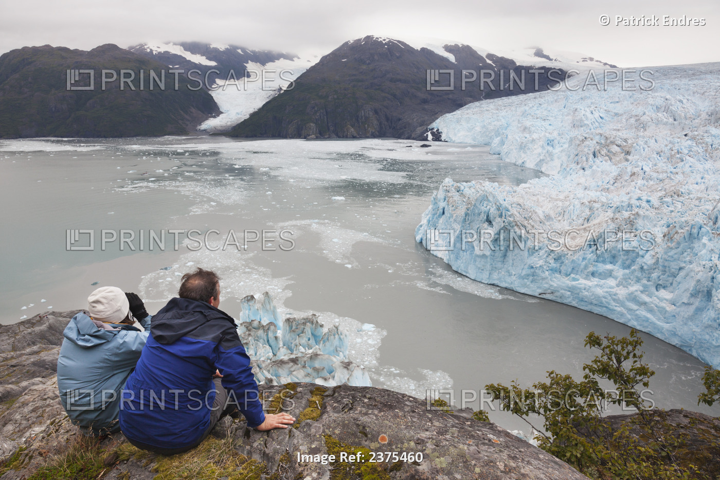 Couple On A Rock Outcrop Overlooking The Tidewater Face Of Chenega Glacier, ...