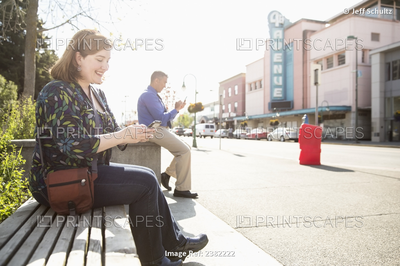 Alaska Native Inupiat Man And Caucasian Woman Using Smart Phone In Downtown ...