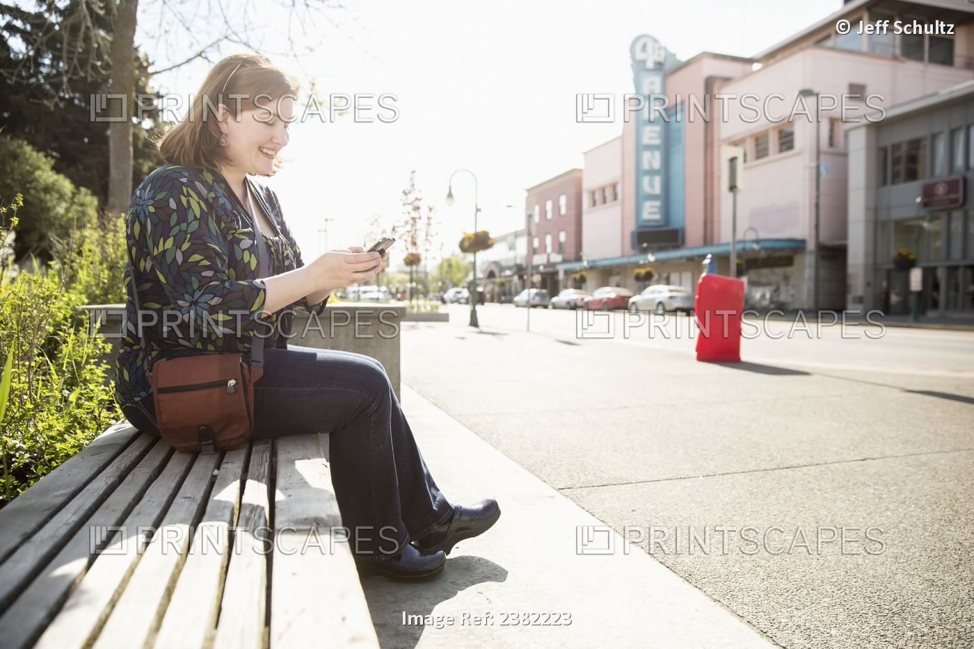 Caucasian Woman Using Smart Phone In Downtown Anchorage, Alaska, Summer