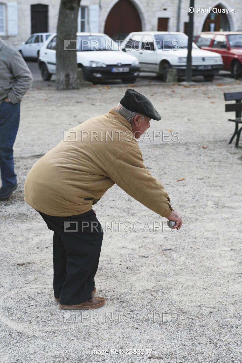 A Man Playing Boule On A Winter Day In The Main Square; Castelnau-Montratier, ...