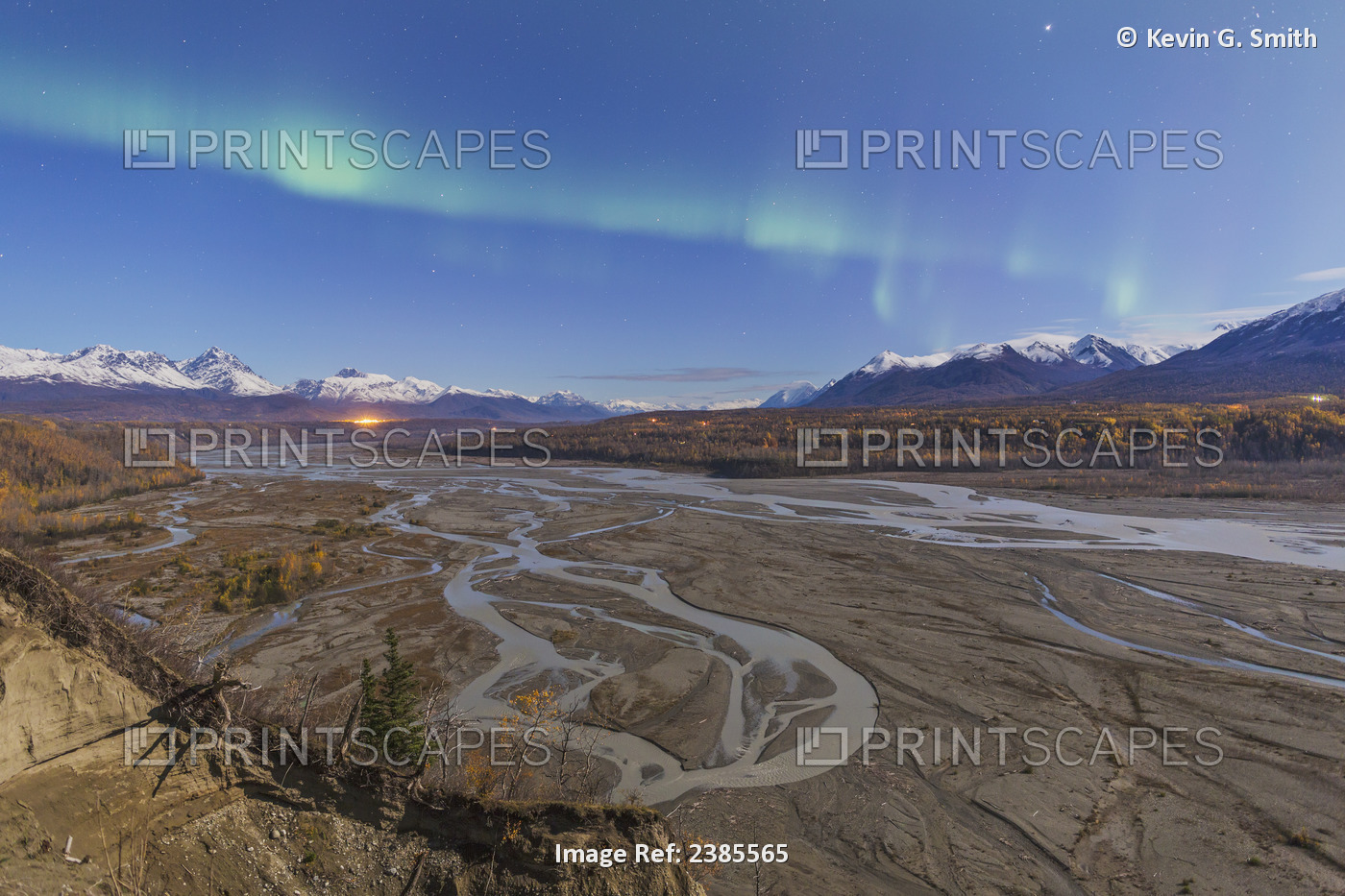 Northern Lights Above Braided Matanuska River Bed With Mountains And City Light ...