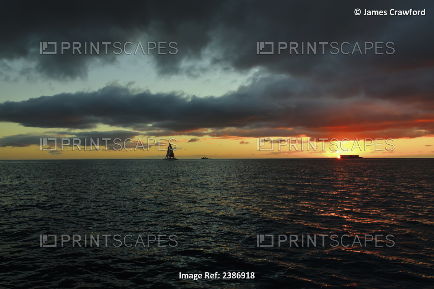 A Sailboat On The Ocean Water Off The Coast Of Waikiki At Sunset; Waikiki, ...