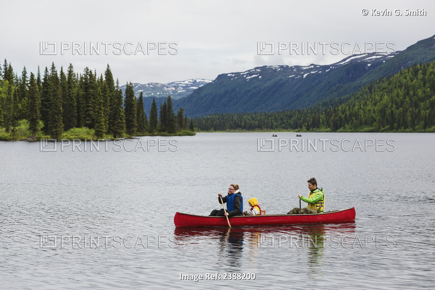 Family In Red Canoe On Byers Lake With Green Tree Covered Hills And Talkeetna ...