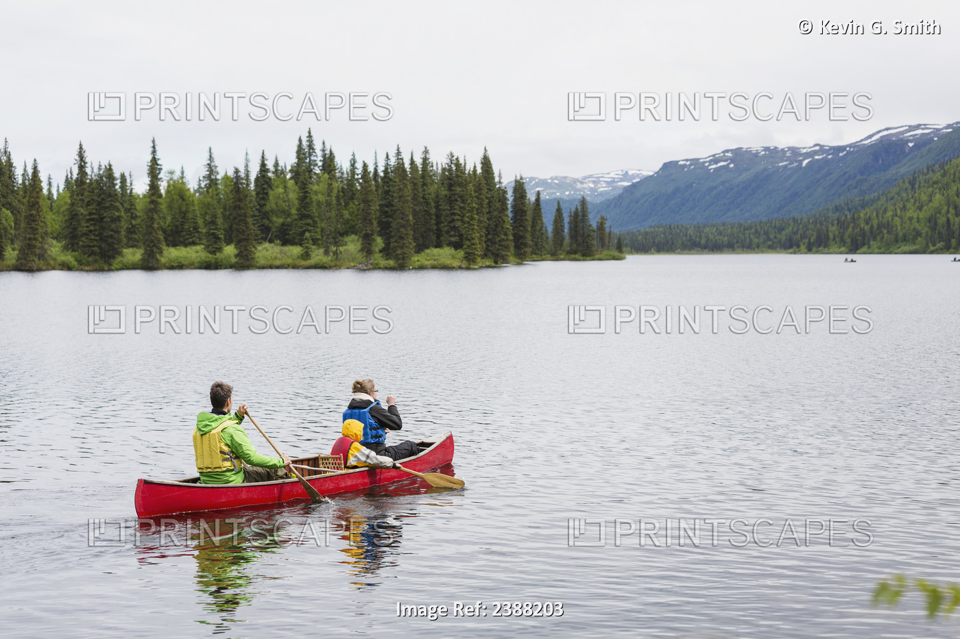 Family In Red Canoe On Byers Lake With Green Tree Covered Shoreline And ...