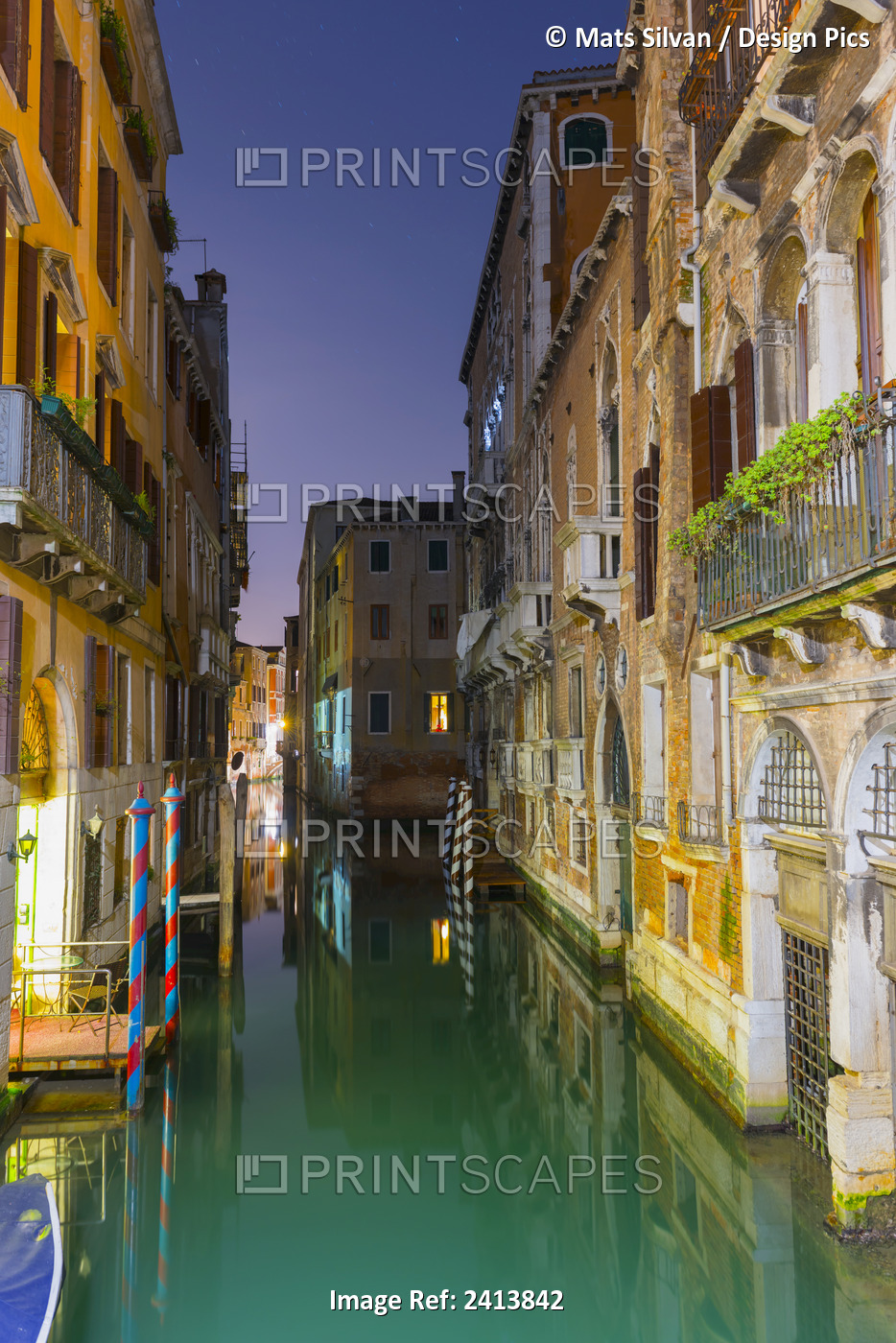 Turquoise Water In A Narrow Canal Between Buildings At Dusk; Venice, Veneto, ...