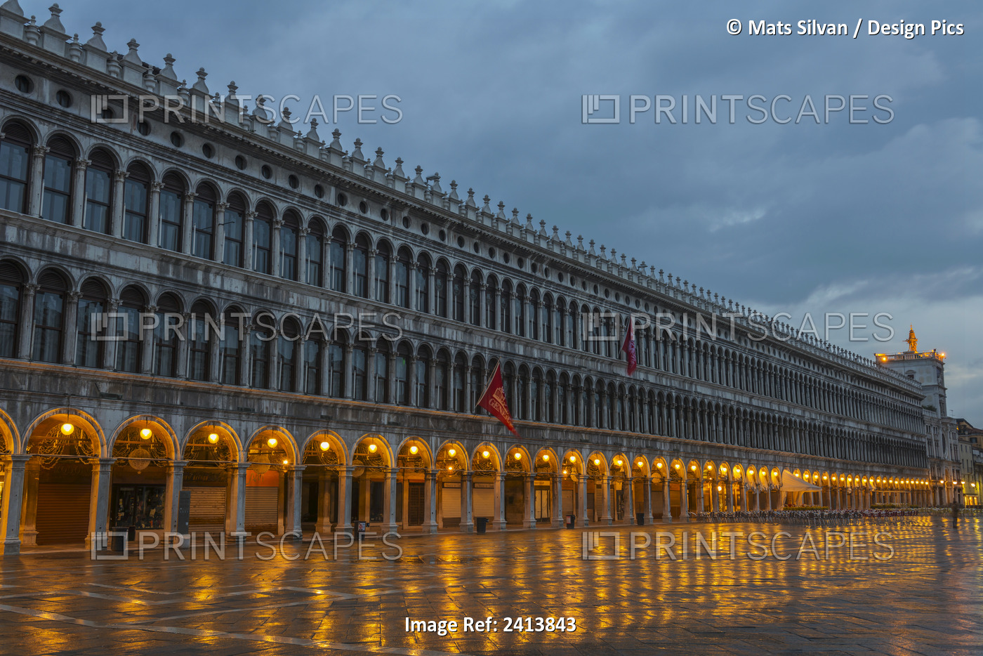Lighted Archways In A Row Along A Building Reflected In The Wet Pavement, ...