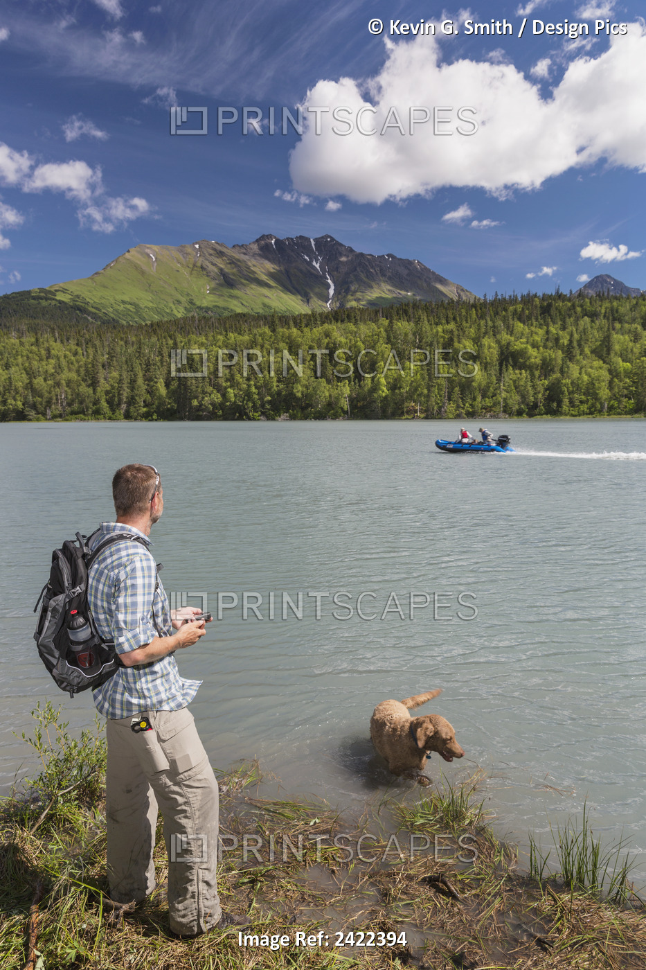 Male Hiker Holding A Cell Phone Standing Next To Trail Lake With Kenai ...
