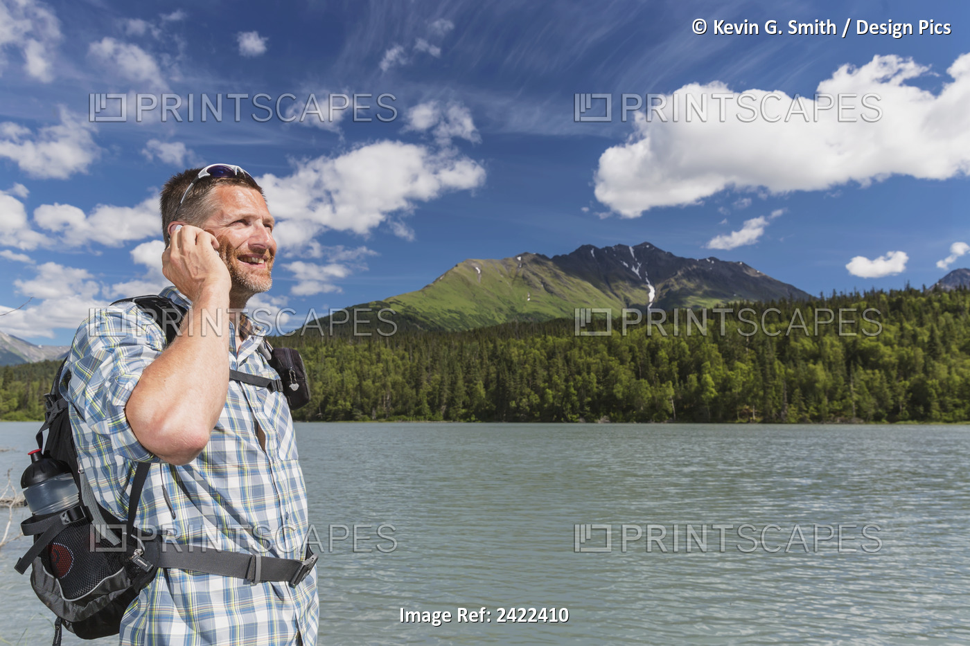 Male Hiker Talking On A Cell Phone Standing Next To Trail Lake With Kenai ...