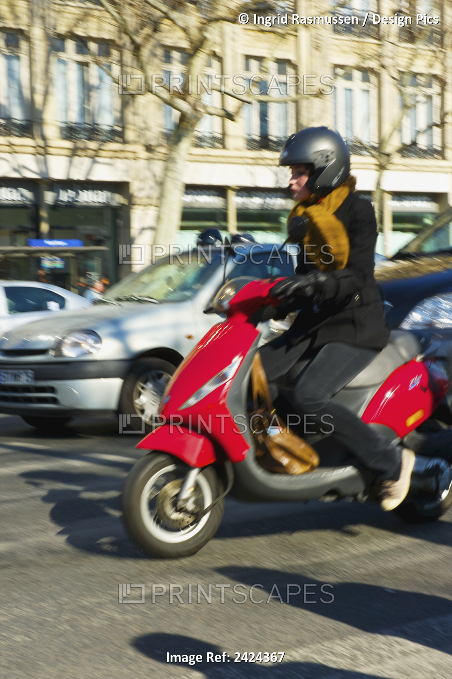 A Woman Driving Her Motorized Scooter Down The Street; Paris, France