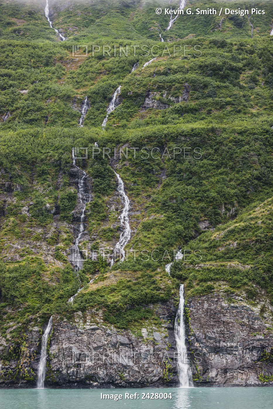 Waterfalls Spilling Down A Green Forested Mountain Side Over A Cliff Into ...