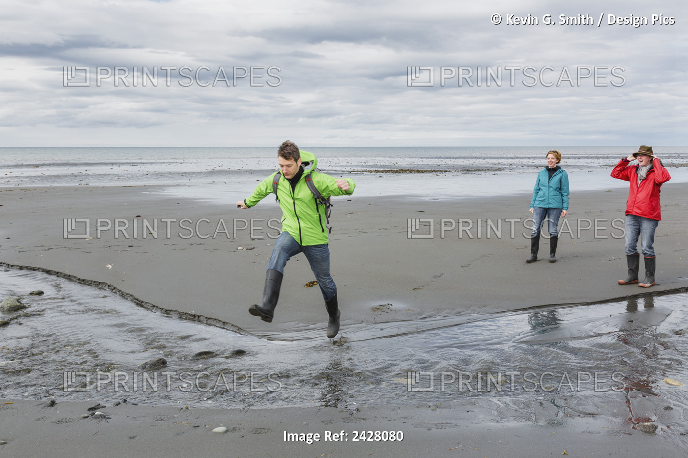Group Of Three Walking On Bishop's Beach, Homer, Kenai Peninsula, Southcentral ...