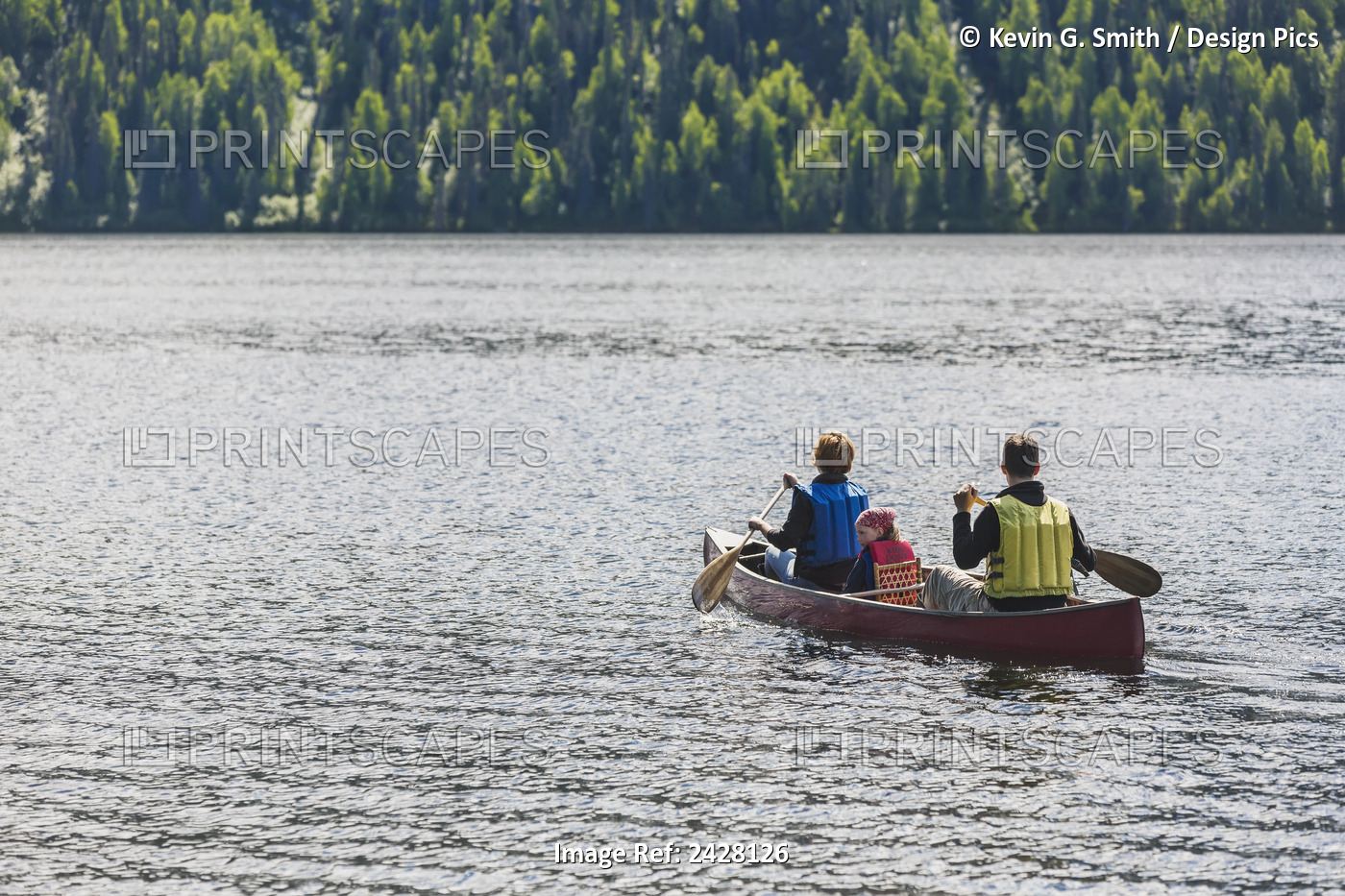 A Couple And Young Girl In A Red Canoe On Byers Lake With Green Forested ...