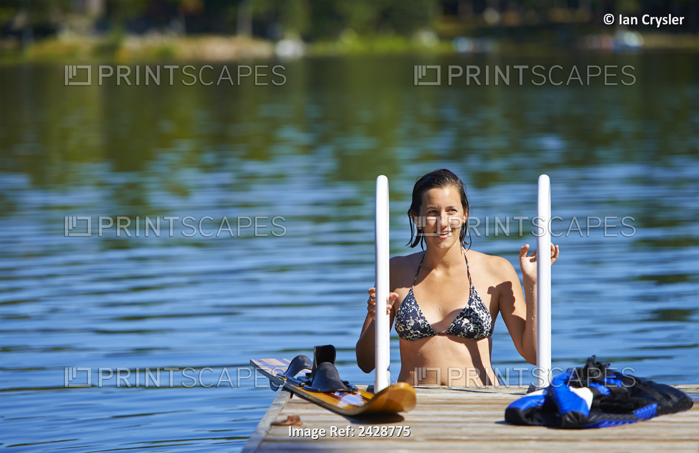 22-Year-Old Girl On Dock Ladder In Water With Water Ski; Ontario, Canada