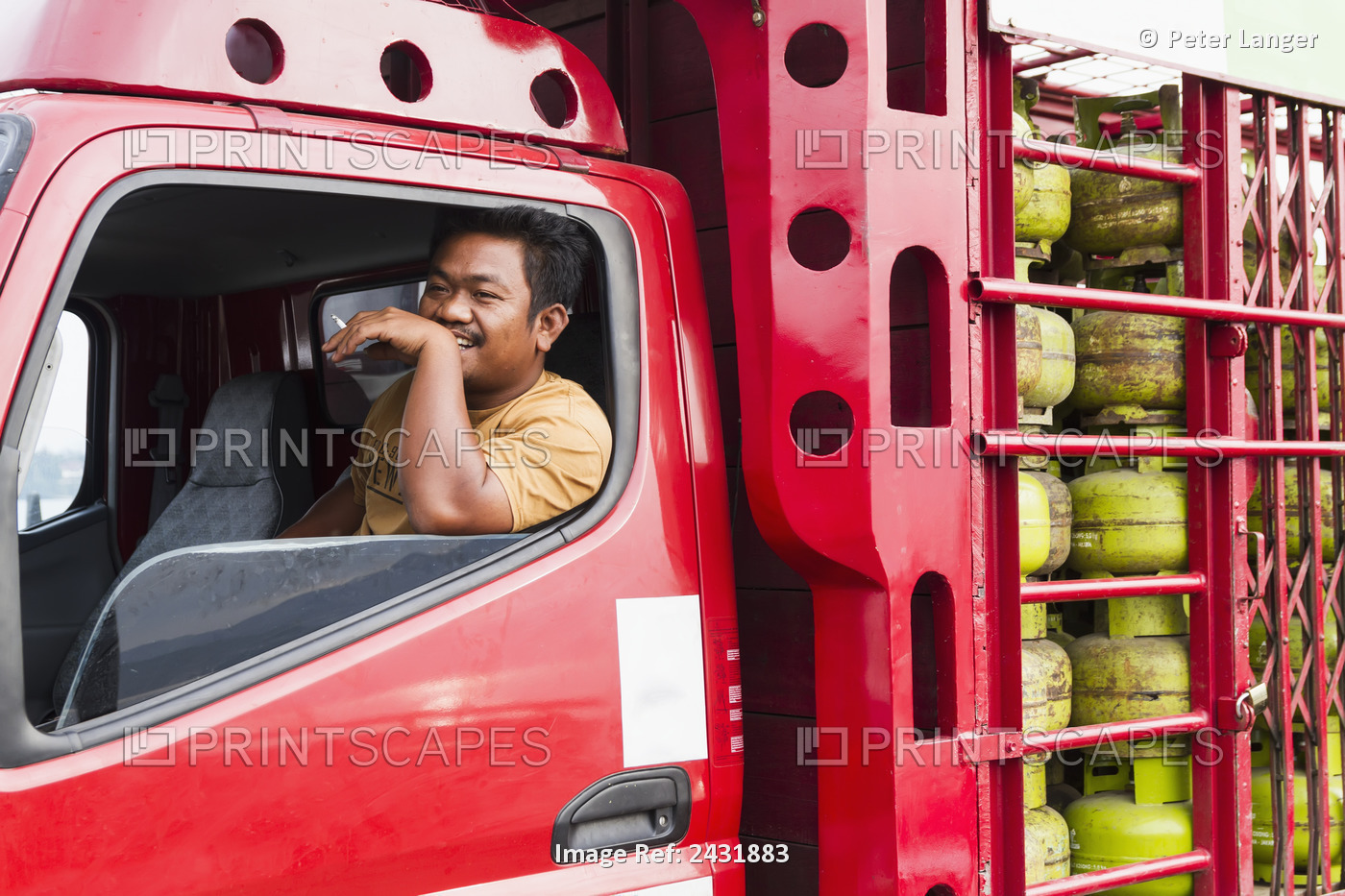 Truck Driver Smoking A Cigarette In A Truck With Gas Containers On Board The ...