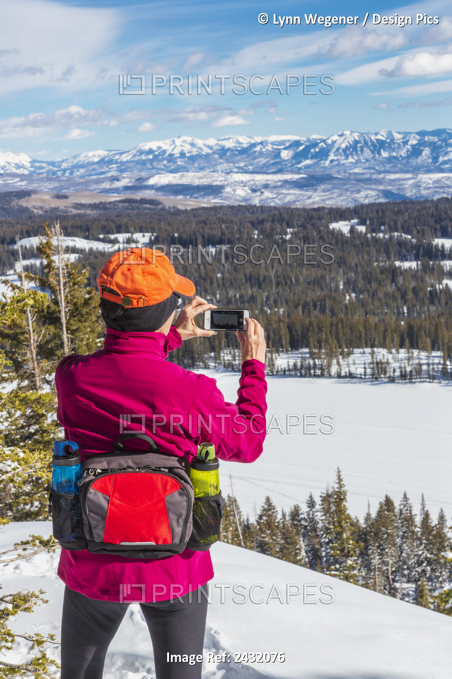 A Woman On Cross Country Skis Takes A Photo With A Smart Phone Of The San Juan ...