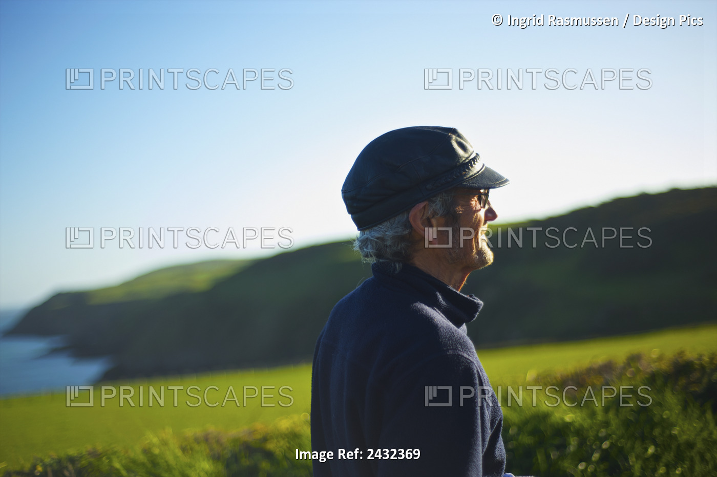 A Man With Sunlight On His Face Looking Out With A Lush Landscape In The ...