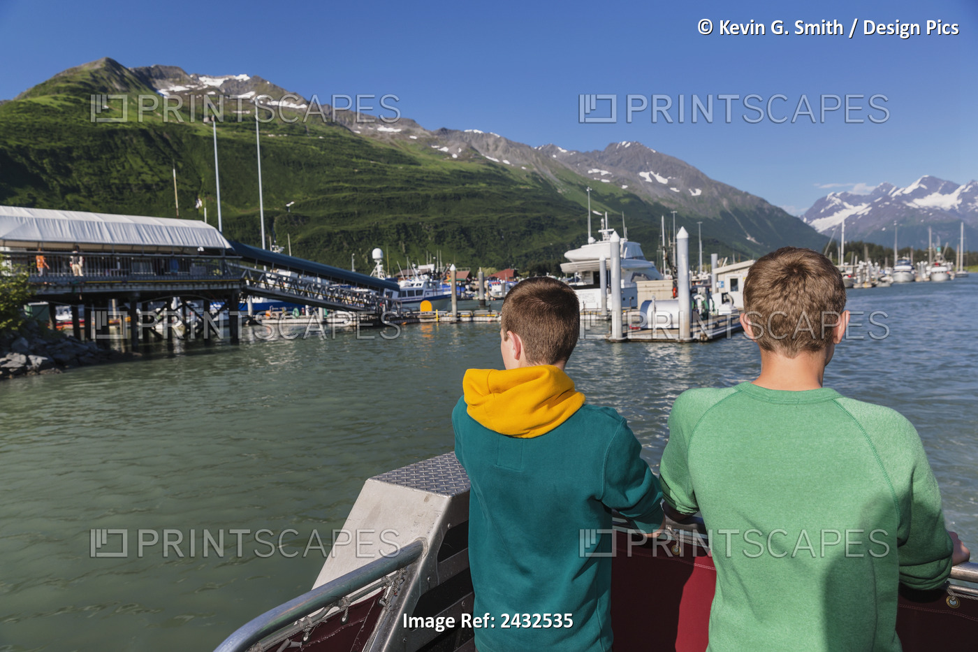Two Teens Stand On The Deck Of A Boat Overlooking The Valdez Small Boat Harbor ...