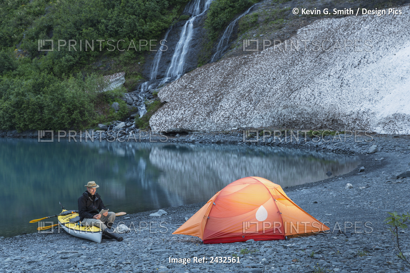 Man Reading On A Electronic Tablet While Camping With A Tent And Kayak At Shoup ...