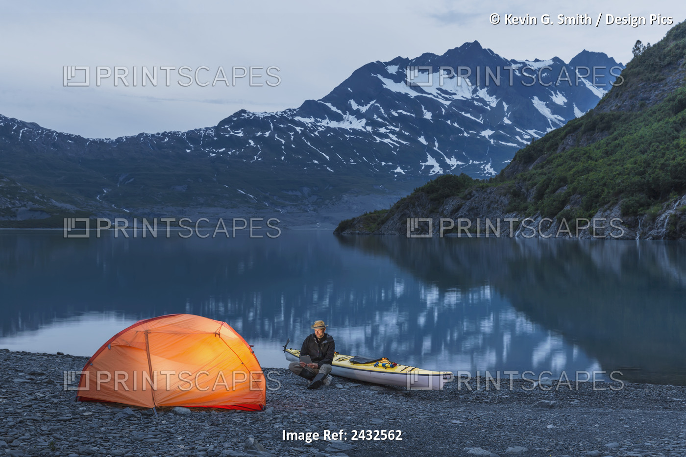 Man Reading On A Electronic Tablet While Camping With A Tent And Kayak At Shoup ...