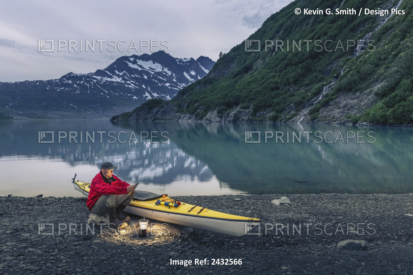 Man Reading On A Electronic Tablet While Camping With A Kayak At Shoup Bay ...