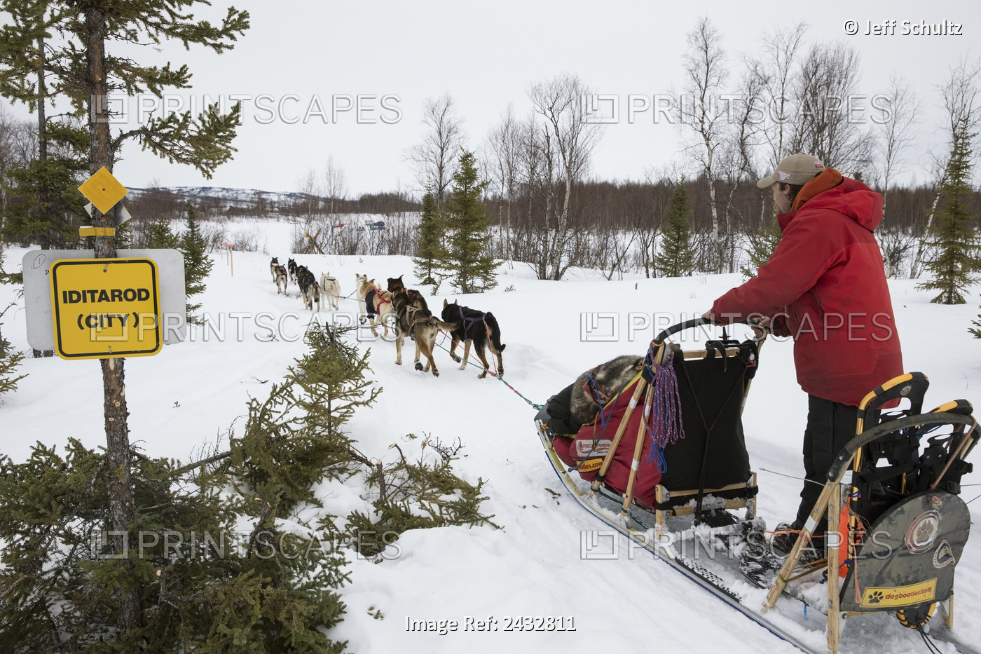 Jason Mackey 's Team Runs Down The Trail Passing A New Sign For Iditarod (City) ...