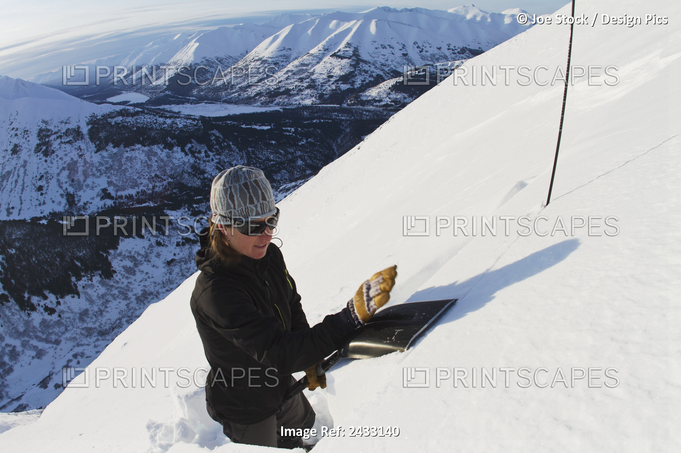 Avalanche Forecaster Analyzing Snow Stability In A Snow Pit While Backcountry ...