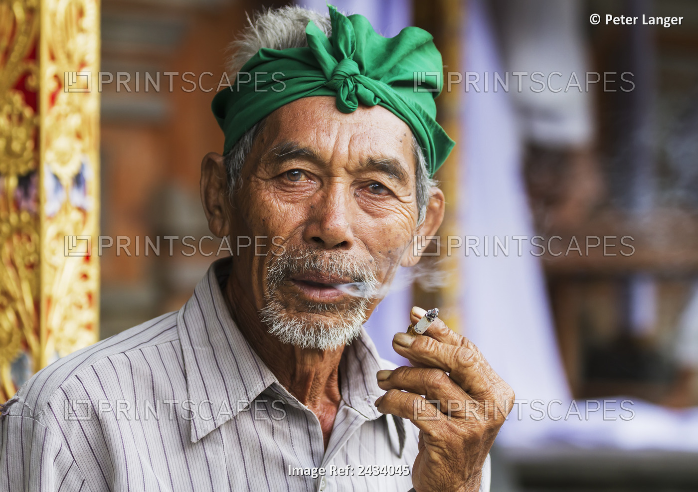 Balinese Man Smoking A Cigarette At Tiirta Empul Temple, Tampaksiring, Bali, ...