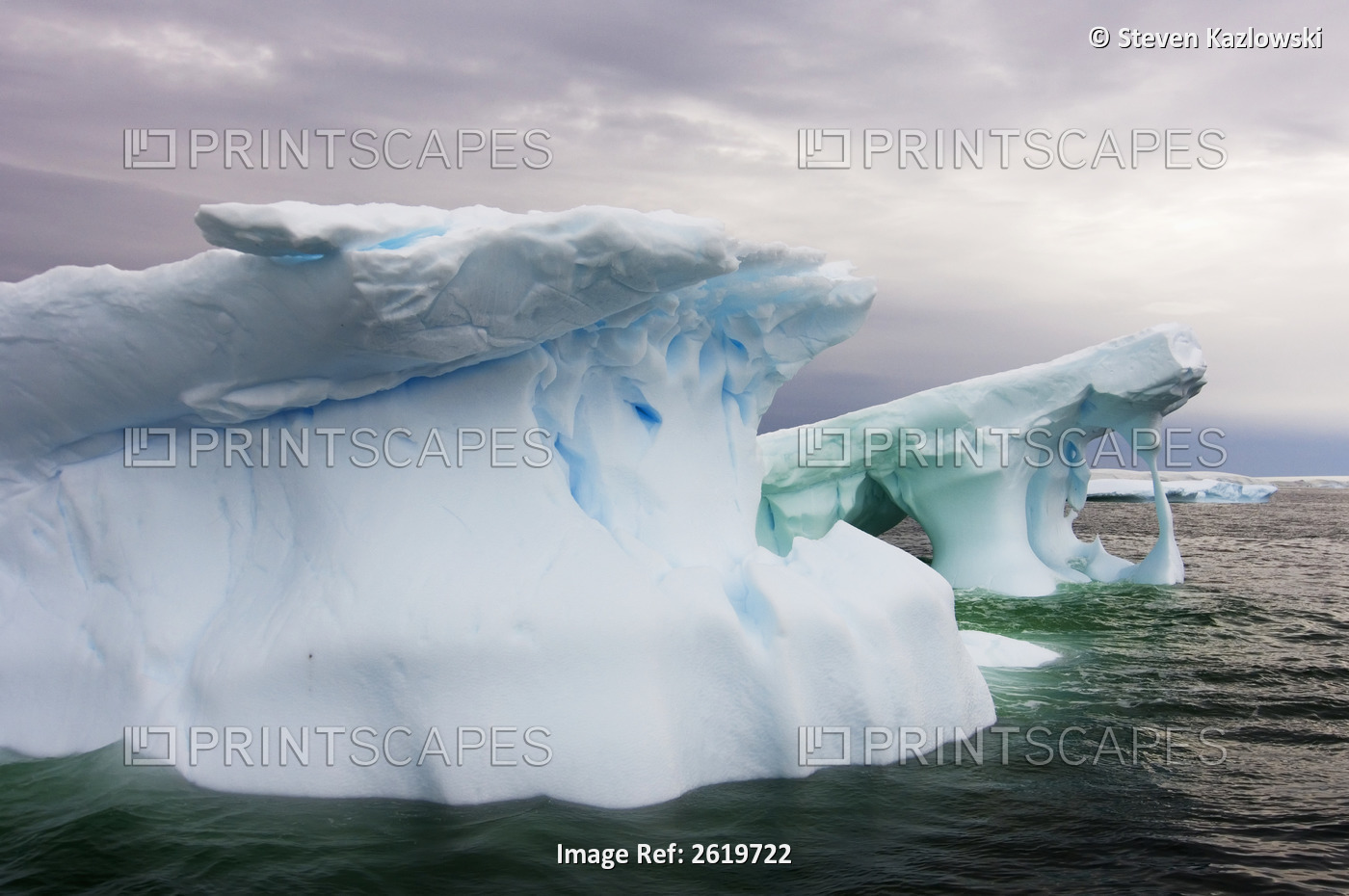 Arched Iceberg Floating Off The Western Antarctic Peninsula, Antarctica, ...