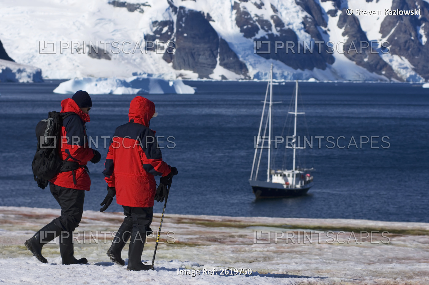 Tourists Walking Near The Coastline Along The Western Antarctic Peninsula