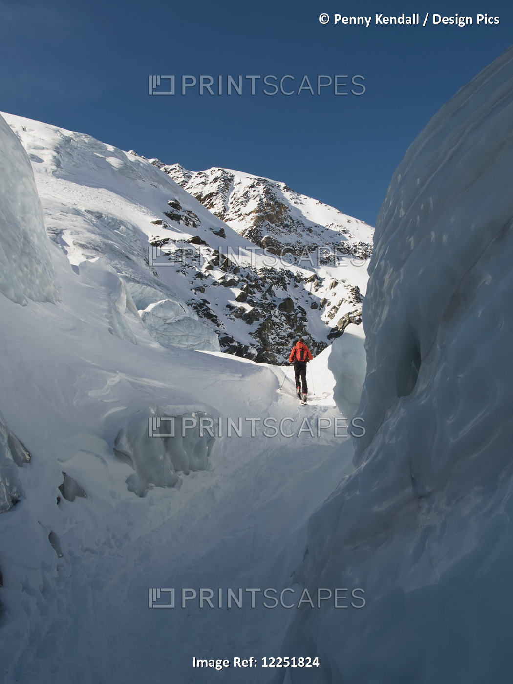 Skier Walking Up Through A Crevasse While Ski-Touring' Sulden, Sudtirol, Italy