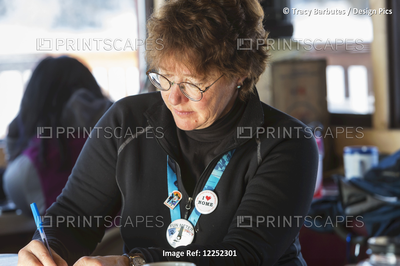 Veterinarian, Kim Henneman, Checks Her Notes While Waiting For A Flight Out Of ...