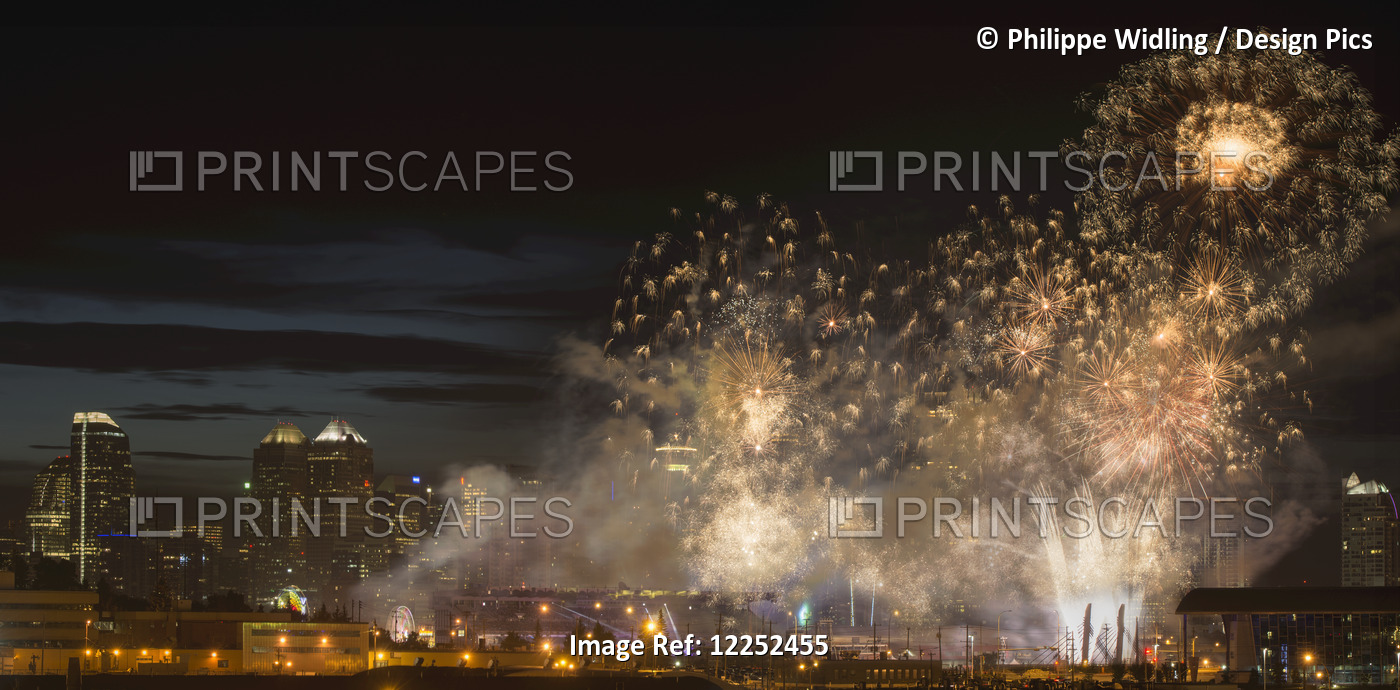 Fireworks In Front Of Modern City Skyline; Calgary, Alberta, Canada