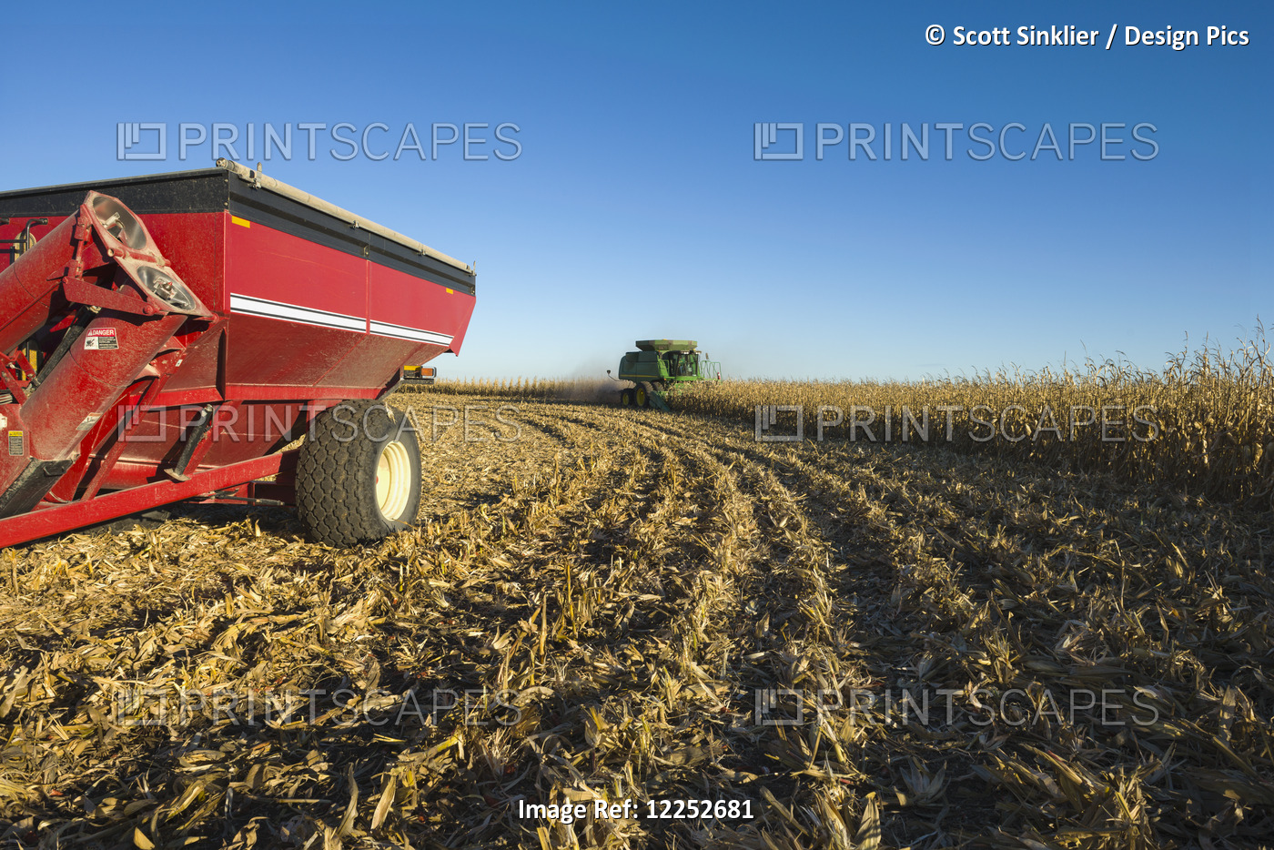 A Farmer Harvests Yellow Grain Corn With His John Deere Combine In Southern ...